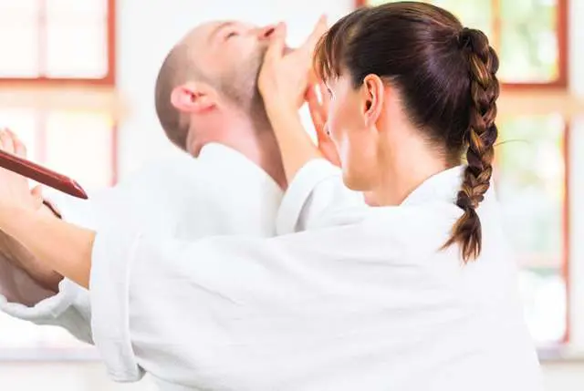 Adults drilling self-defense techniques